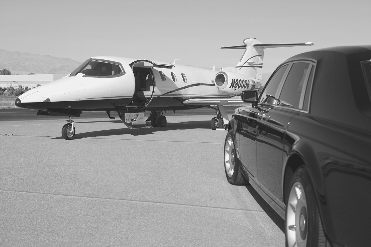 limousine and private jet on landing strip.